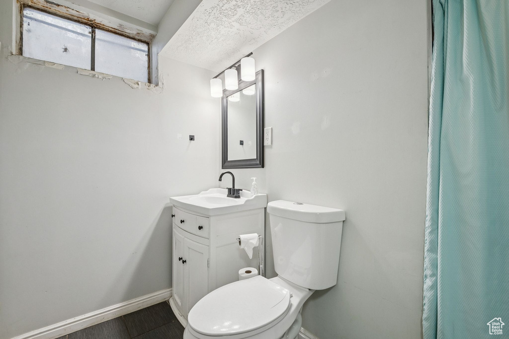 Full bath featuring vanity and curtained shower
