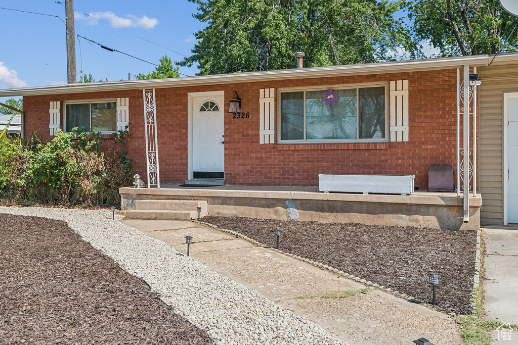 Ranch-style house featuring brick siding