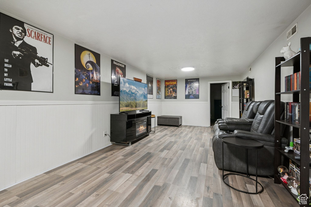 Living room with wood finished floors and wainscoting