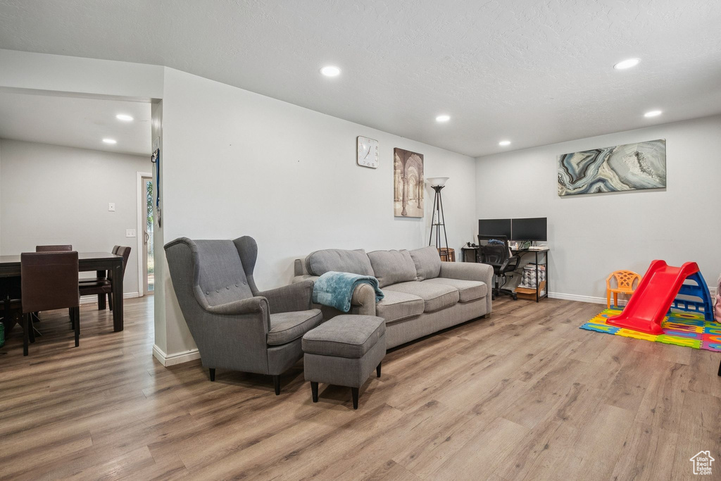 Living room featuring wood finished floors and recessed lighting