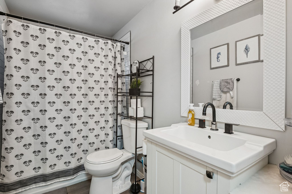 Bathroom with a shower with shower curtain and vanity
