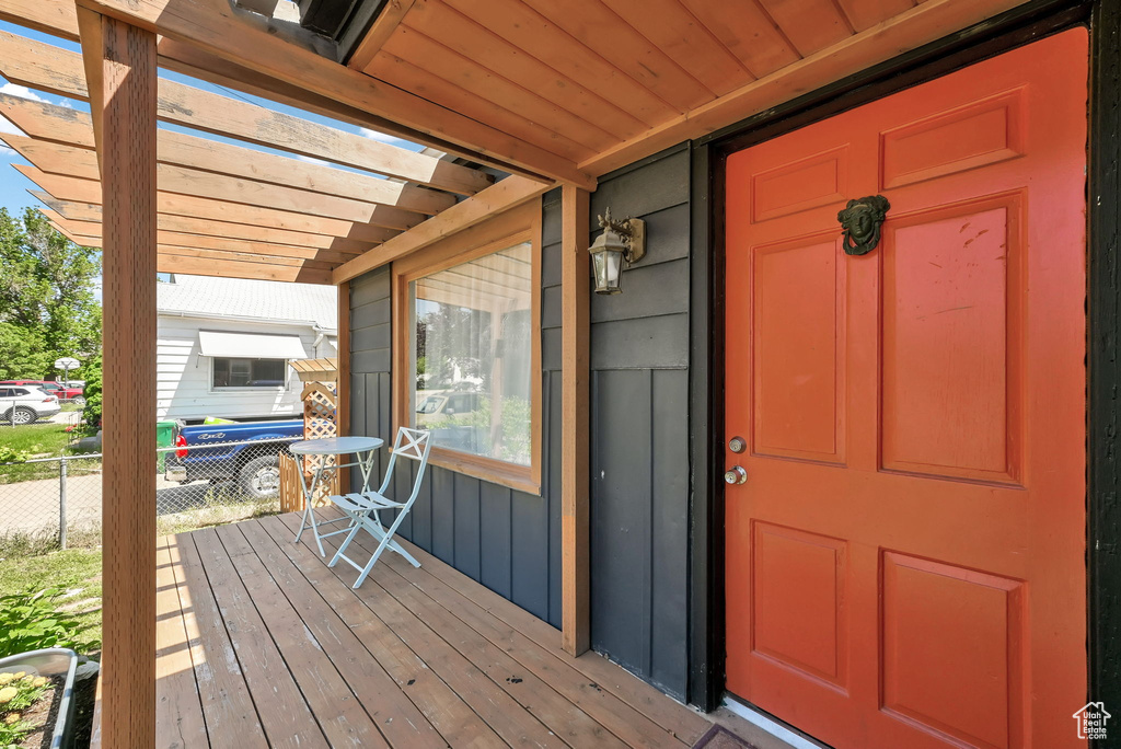 Entrance to property with a pergola and covered porch