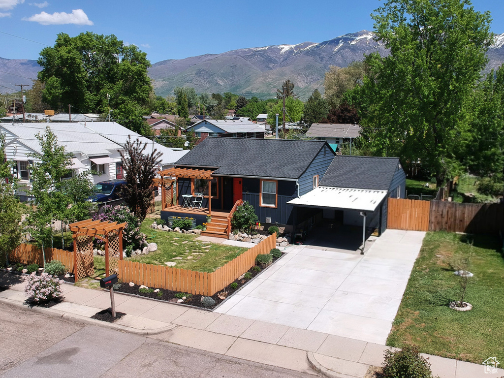 Bungalow-style home featuring driveway, a mountain view, and a carport