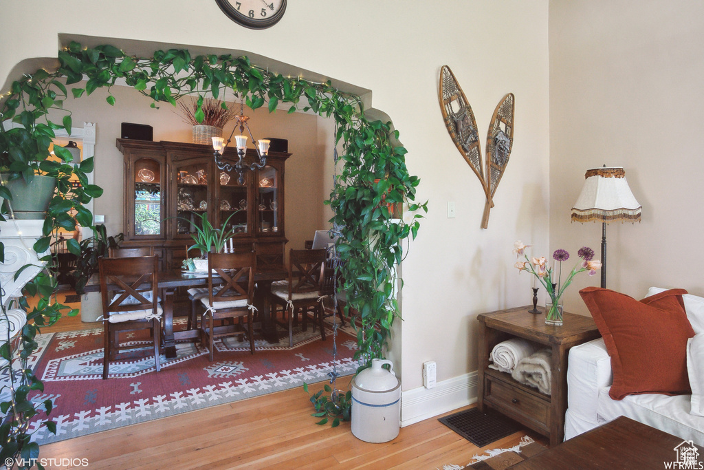 Dining room featuring wood finished floors and a chandelier