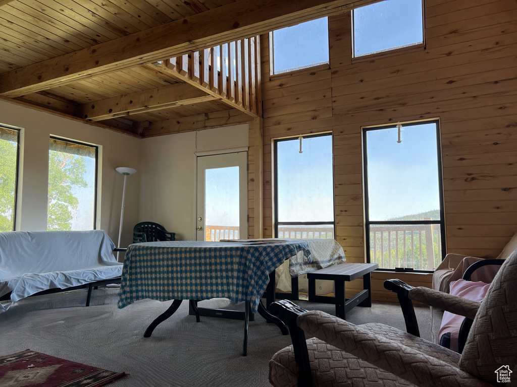 Living area featuring carpet flooring and beamed ceiling
