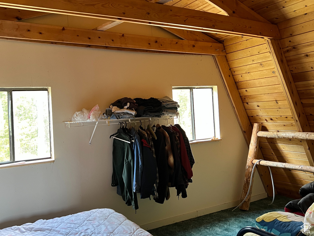 Carpeted bedroom with wooden ceiling