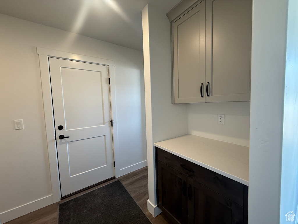 Kitchen with dark wood-style floors and light countertops