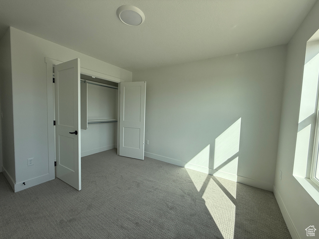 Unfurnished bedroom with carpet floors and a closet