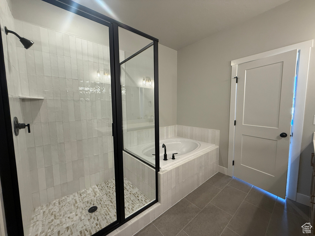 Full bath featuring tile patterned flooring, a shower stall, and a bath