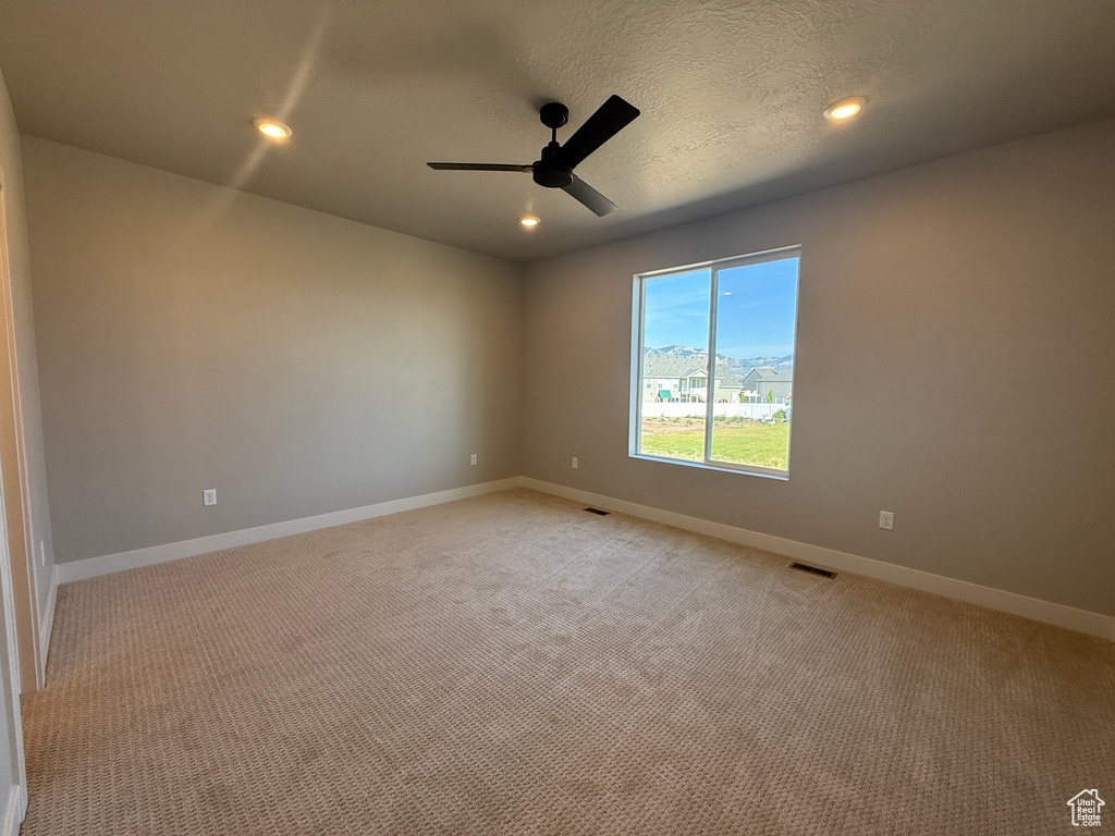 Unfurnished room featuring a ceiling fan, light carpet, and recessed lighting