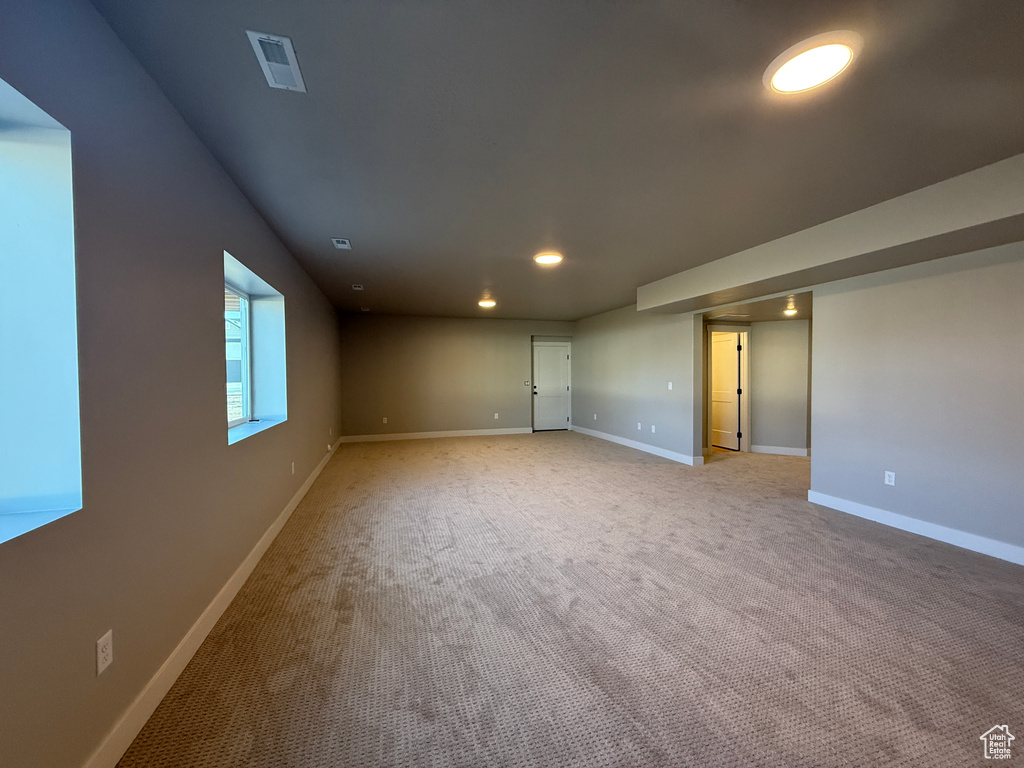 Spare room featuring recessed lighting and light carpet