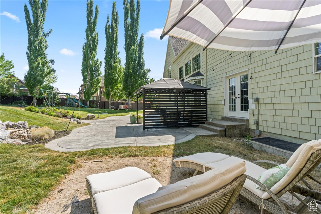 View of patio / terrace featuring french doors, a gazebo, and a playground
