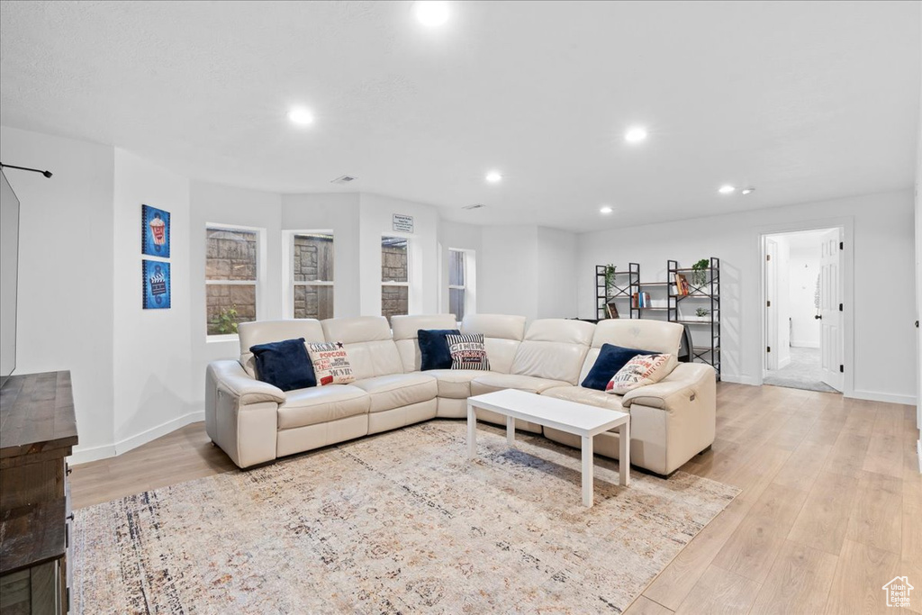 Living area featuring light wood-style flooring and recessed lighting