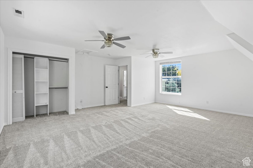 Unfurnished bedroom featuring carpet flooring and ceiling fan