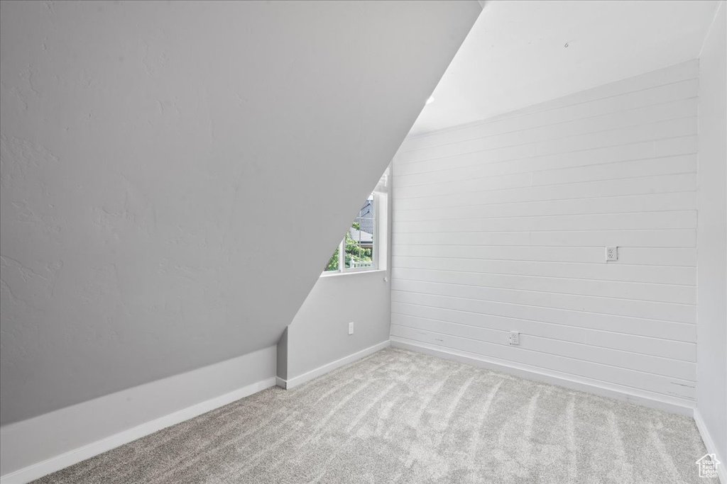 Bonus room with carpet and lofted ceiling