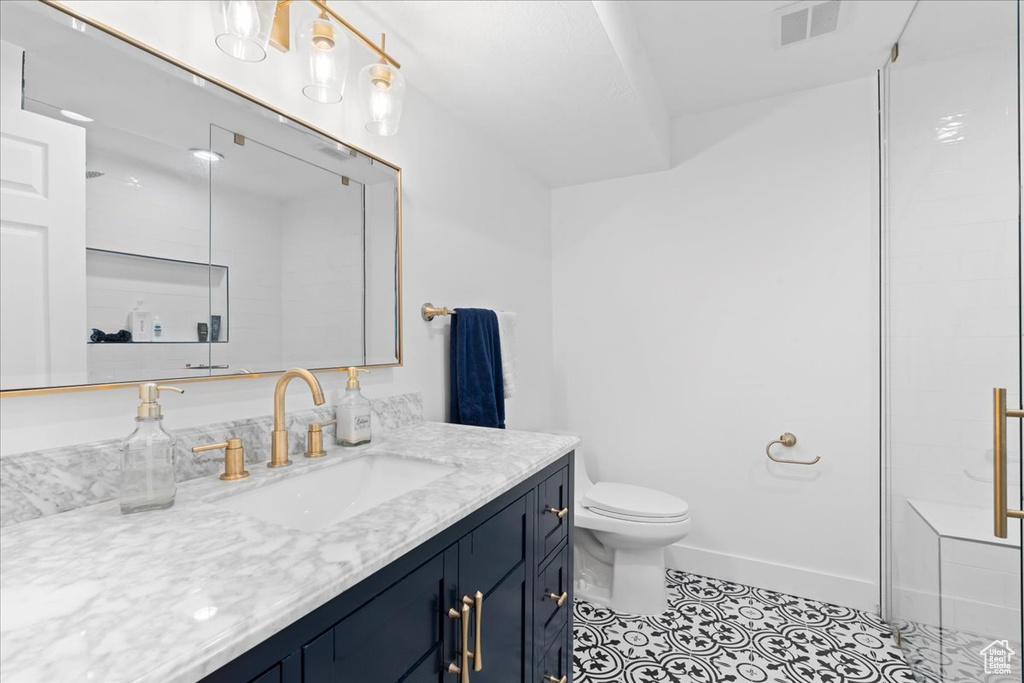 Full bathroom featuring vanity, tile patterned floors, and a shower