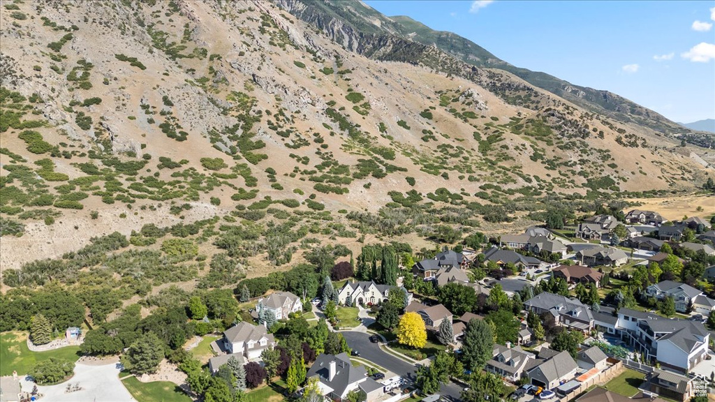Aerial view of property's location featuring mountains and nearby suburban area