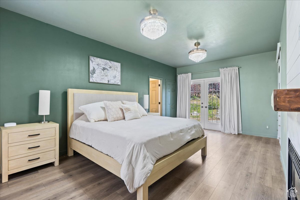 Bedroom with french doors, wood finished floors, and access to exterior