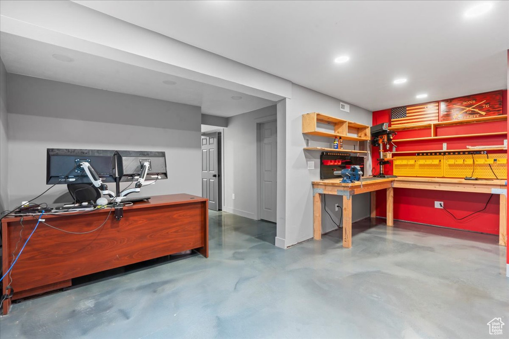Office featuring a workshop area, concrete flooring, and recessed lighting