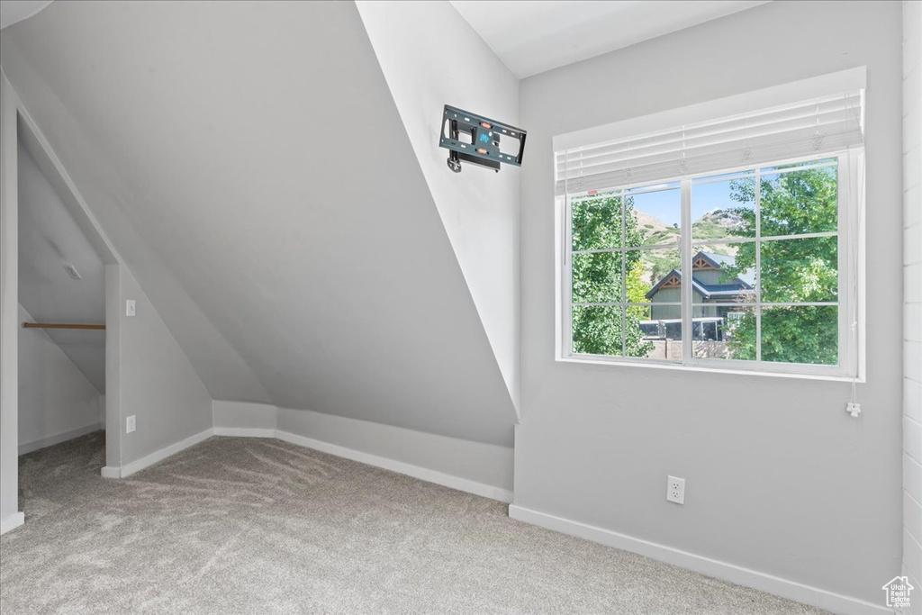 Additional living space featuring carpet floors and baseboards