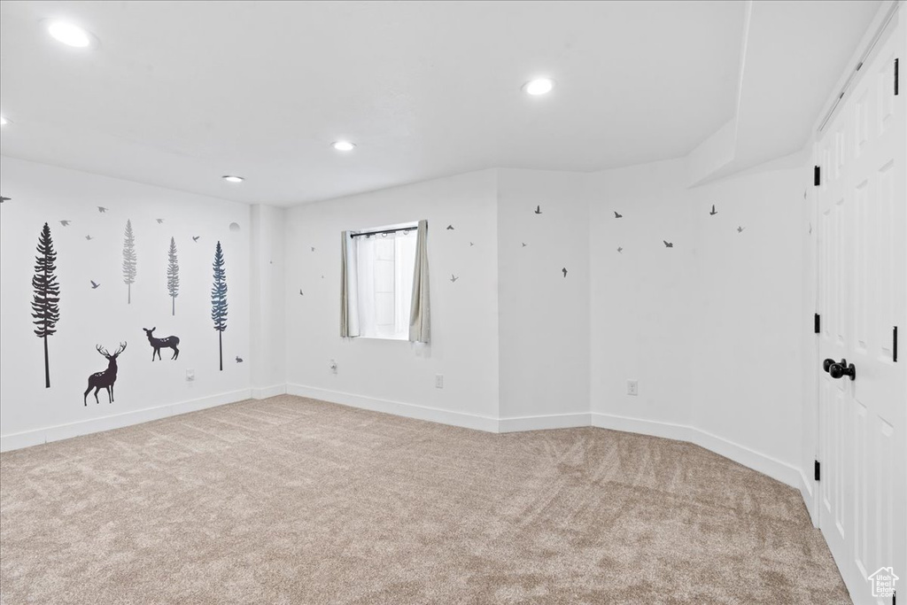 Spare room featuring light carpet and recessed lighting