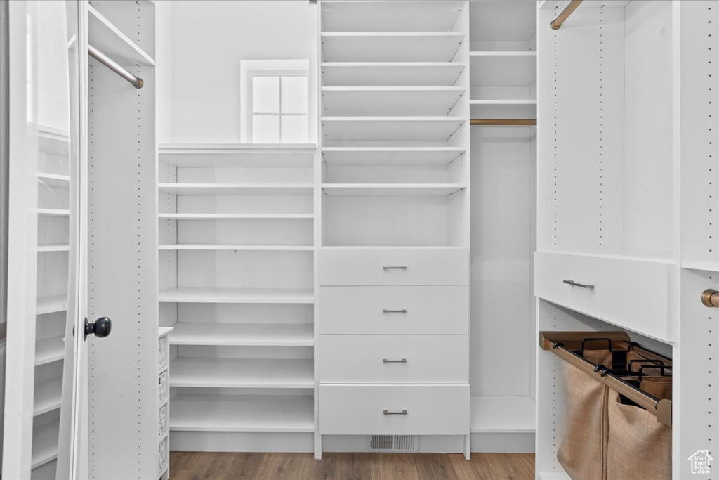 Walk in closet featuring wood finished floors