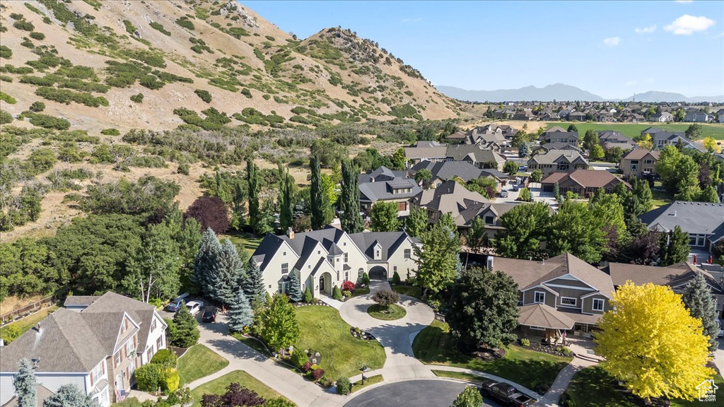 Aerial perspective of suburban area featuring a mountain backdrop