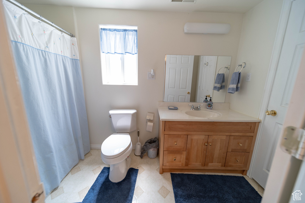 Full bathroom featuring vanity and a shower with shower curtain