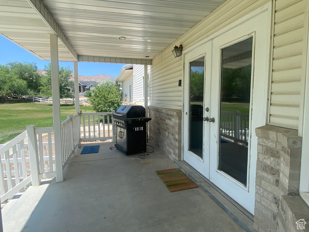 Porch featuring a grill and french doors