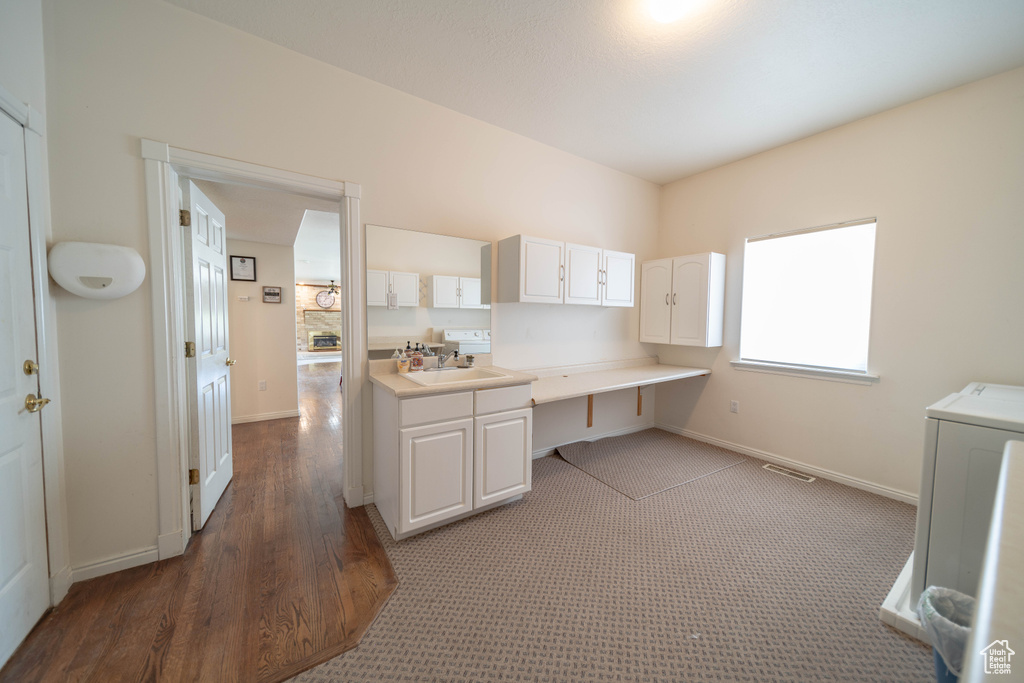 Unfurnished office with washer / clothes dryer and light wood-style flooring