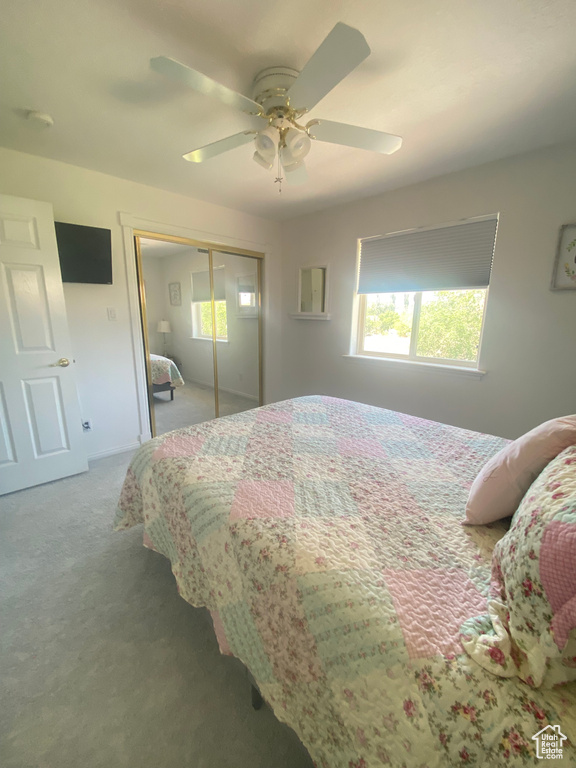 Bedroom featuring carpet floors, a closet, and a ceiling fan