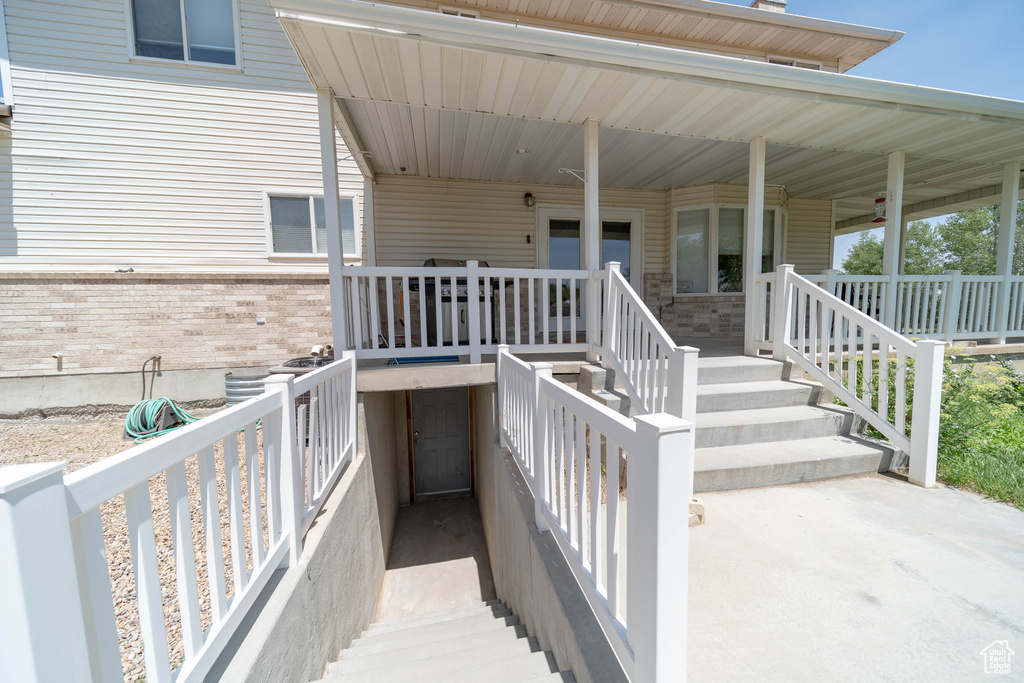 Property entrance with brick siding and covered porch