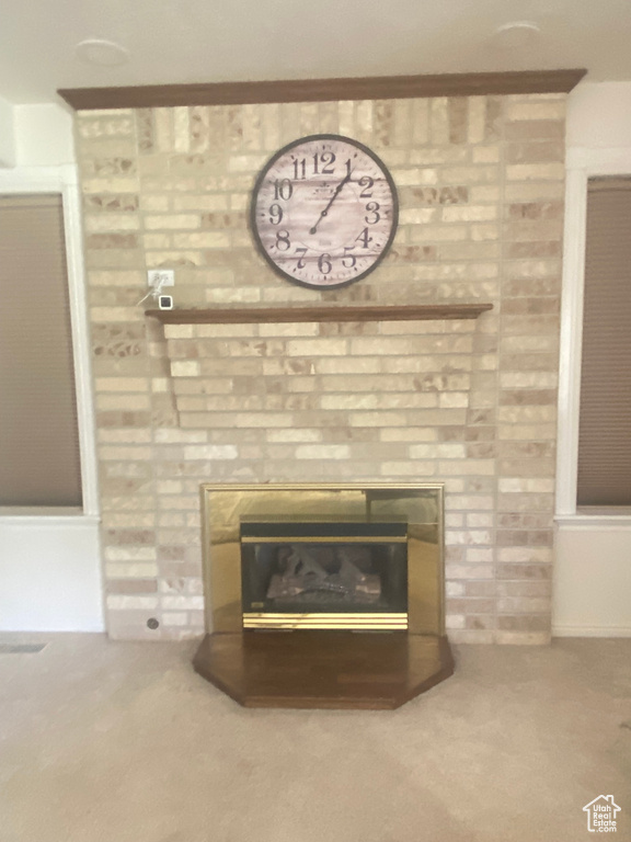 Detailed view of carpet and a large fireplace