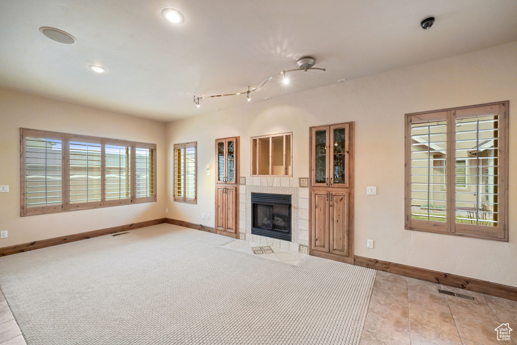 Unfurnished living room featuring a fireplace and recessed lighting