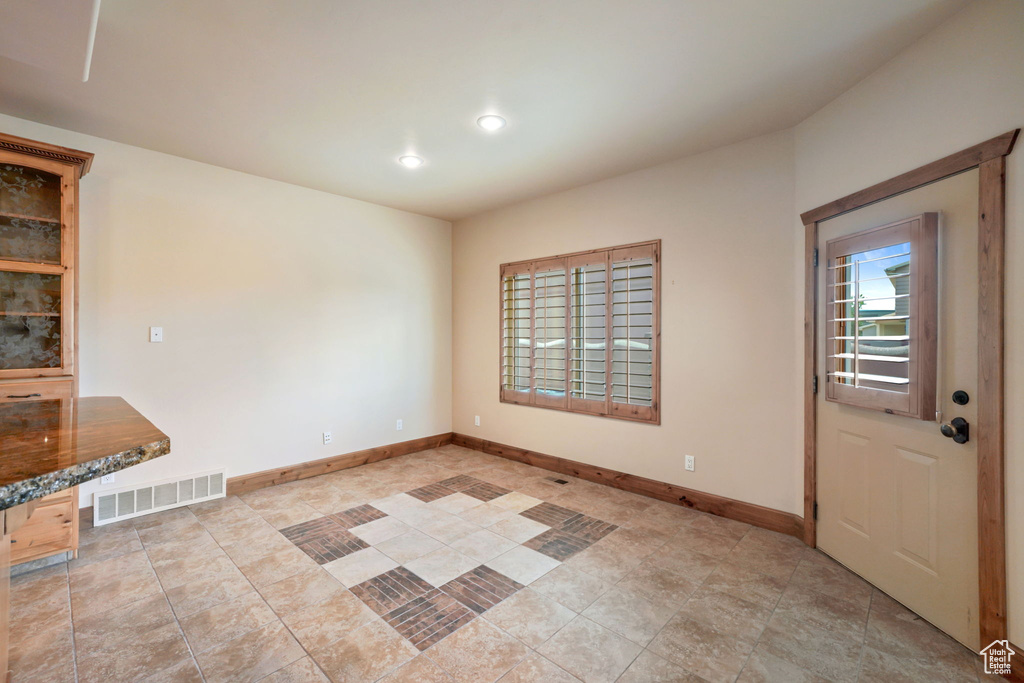 Unfurnished dining area featuring baseboards and recessed lighting