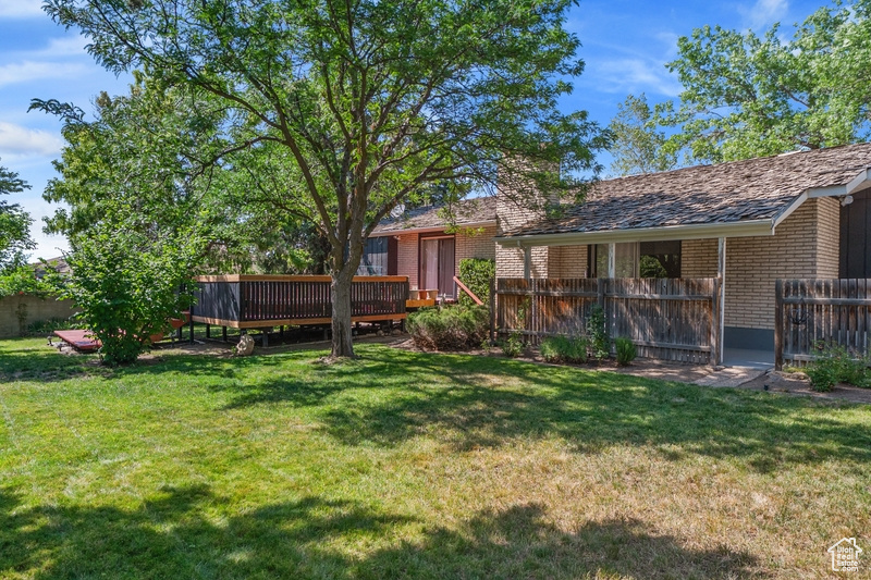 View of yard featuring a wooden deck