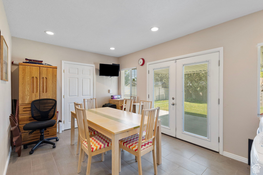 Dining space with french doors, recessed lighting, and light tile patterned floors