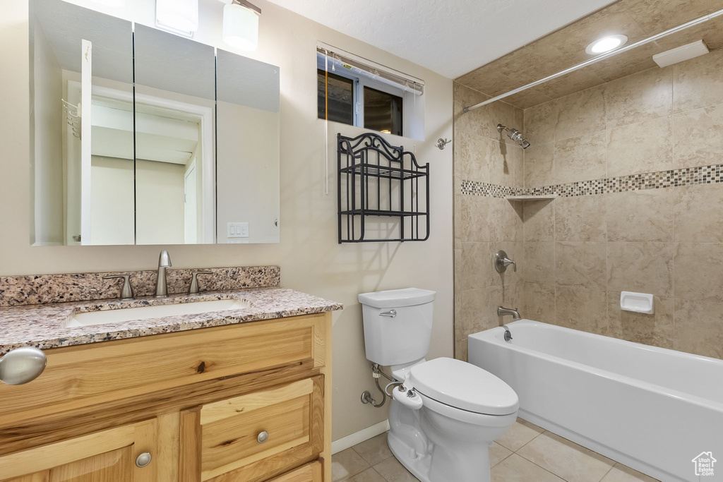 Bathroom featuring tile patterned floors, tub / shower combination, and vanity