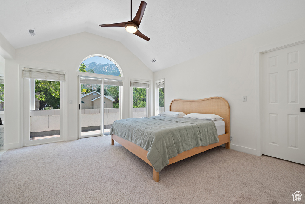 Bedroom featuring access to outside, light carpet, a ceiling fan, and high vaulted ceiling