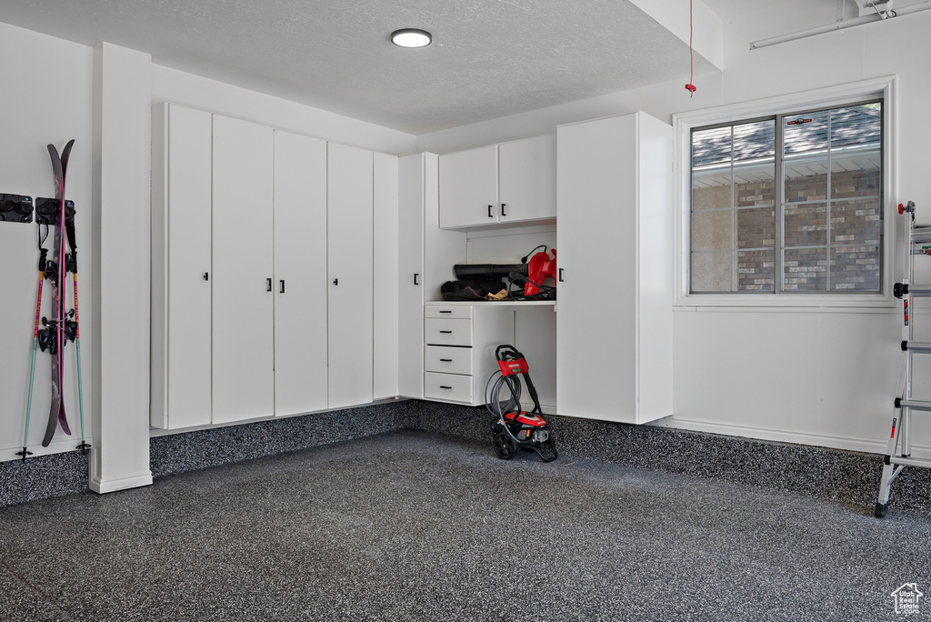 Garage featuring baseboards
