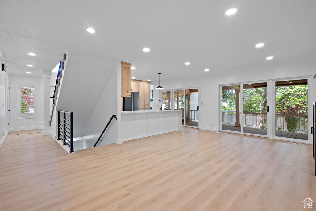 Unfurnished living room with light wood-style flooring and recessed lighting