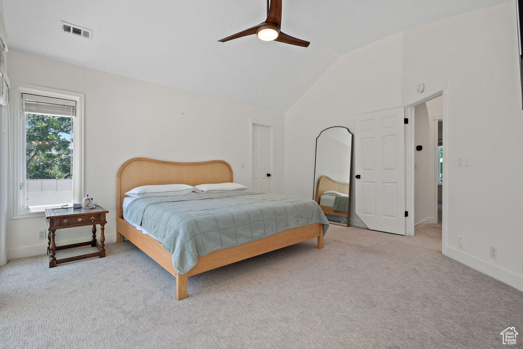 Bedroom featuring lofted ceiling, carpet flooring, and a ceiling fan