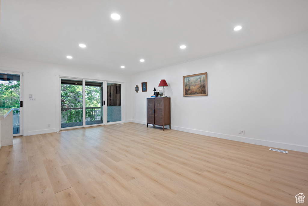 Unfurnished living room with light wood-type flooring and recessed lighting