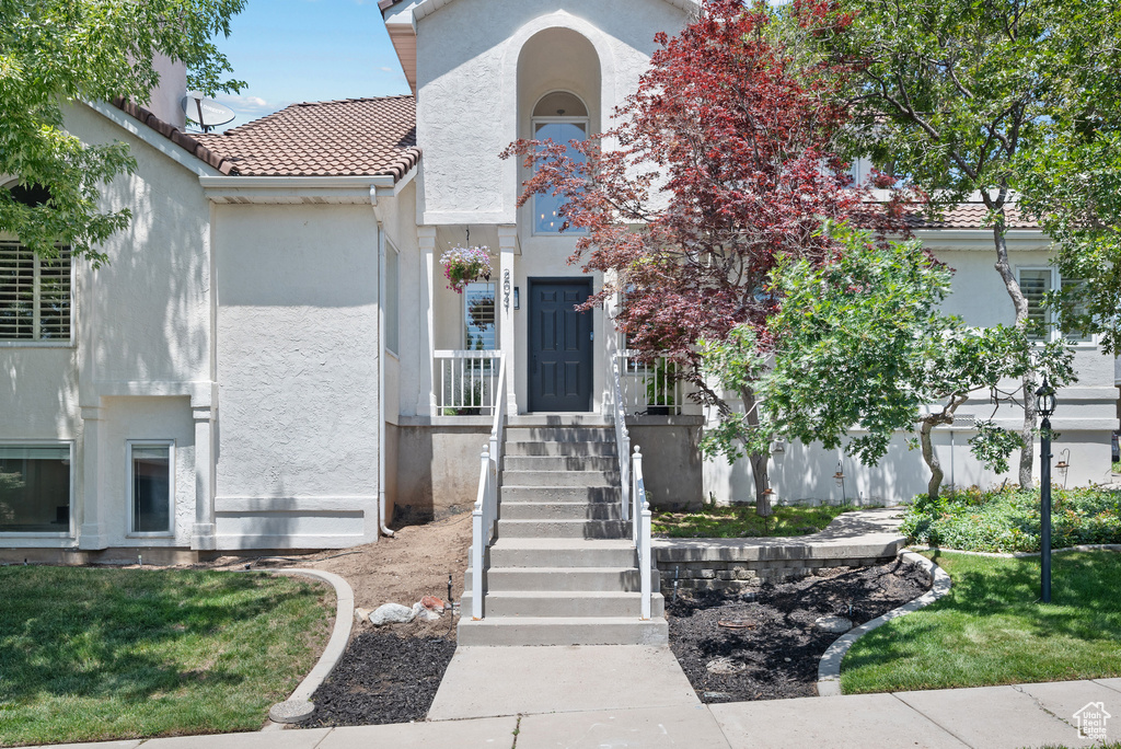 Mediterranean / spanish-style house with stucco siding and a tile roof