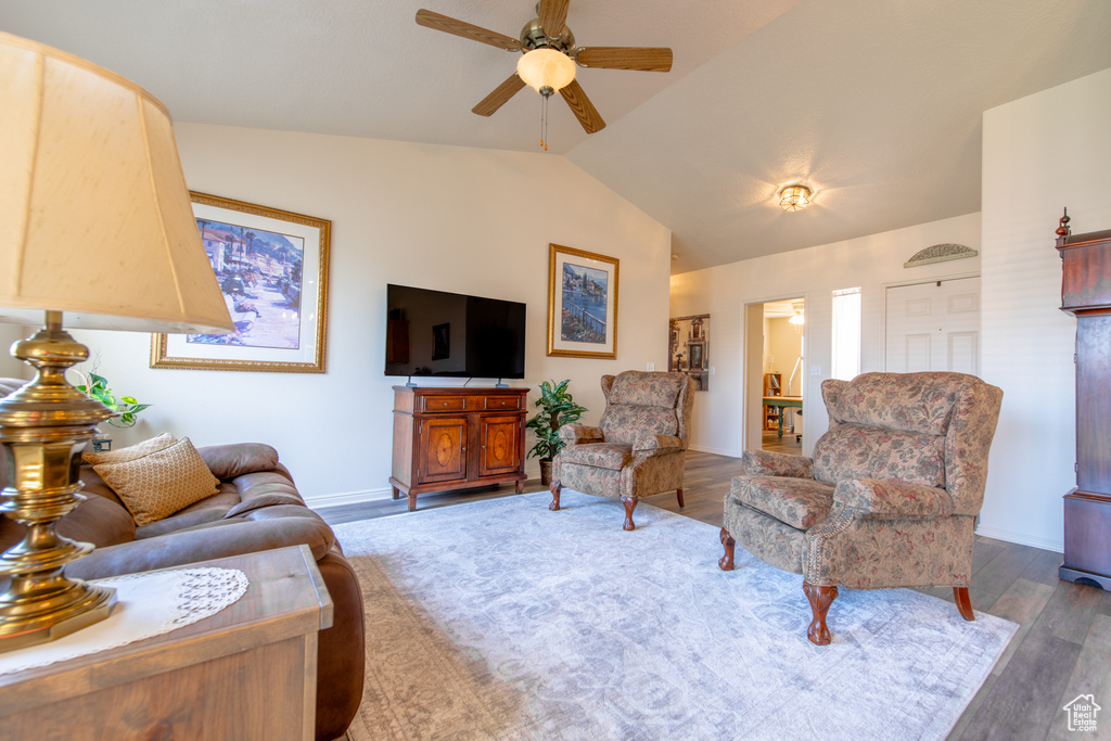Living room featuring ceiling fan, lofted ceiling, and wood finished floors