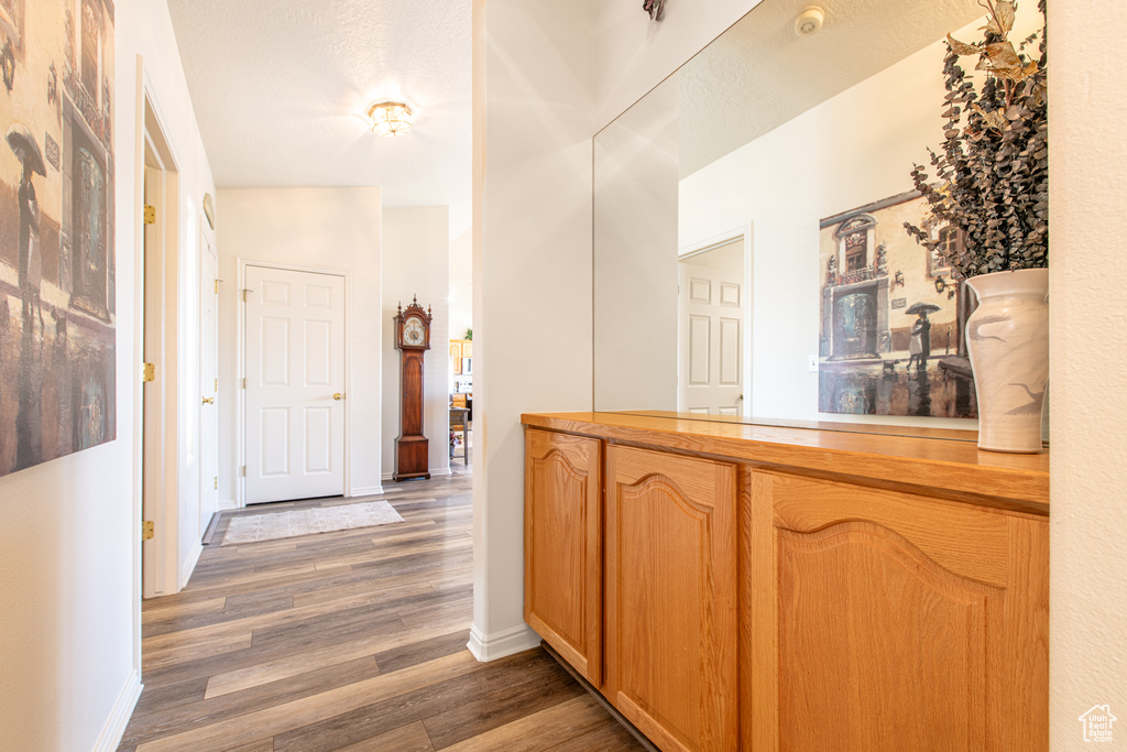 Hall with wood finished floors and baseboards