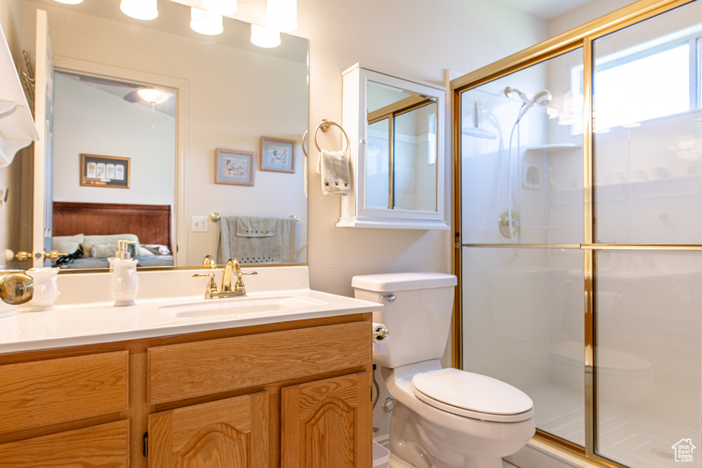 Ensuite bathroom featuring a shower stall and vanity
