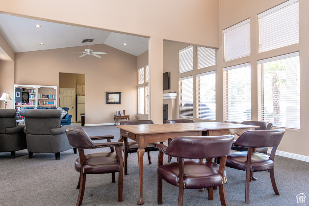 Dining area featuring high vaulted ceiling, carpet flooring, a ceiling fan, and recessed lighting
