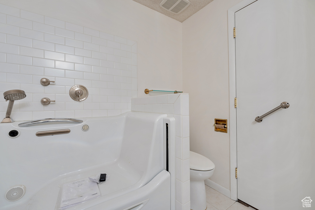Full bathroom featuring tile patterned flooring and a tub