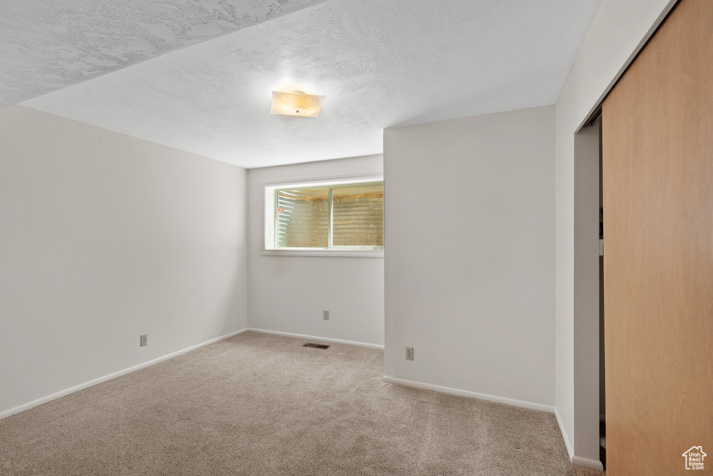 Unfurnished bedroom with carpet and a closet